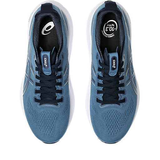 Pair of blue running shoes with black laces on a white background