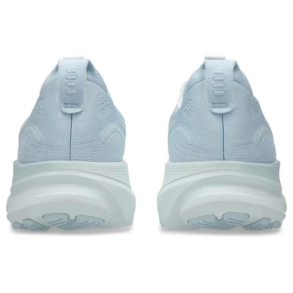 Light blue running shoes with white soles on a white background