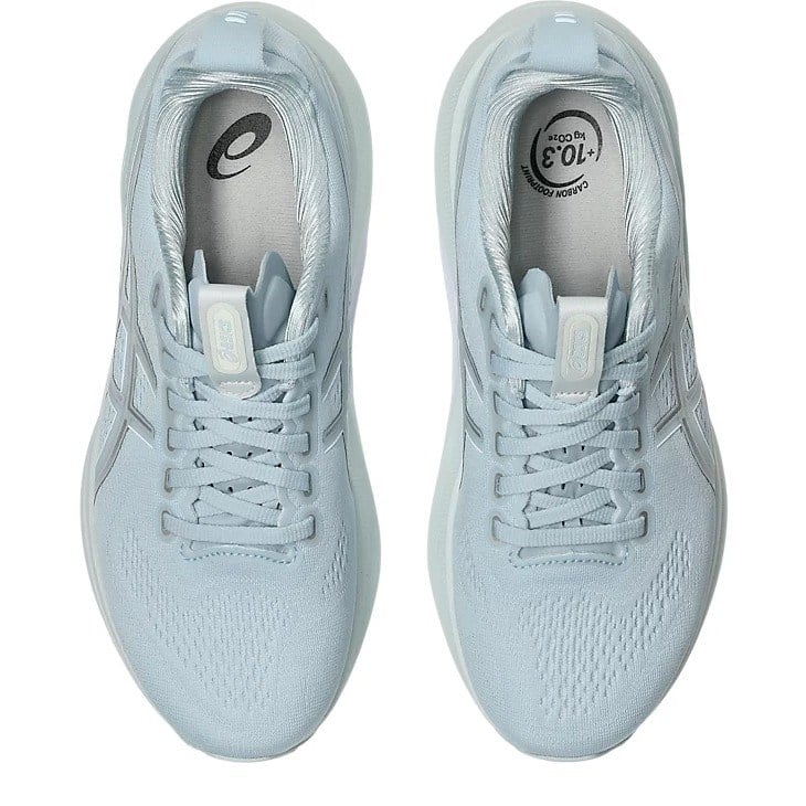 Pair of light blue running shoes on a white background
