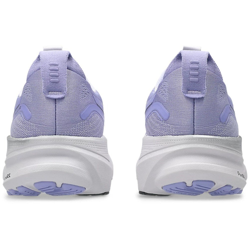 Purple running shoes with white soles on a white background
