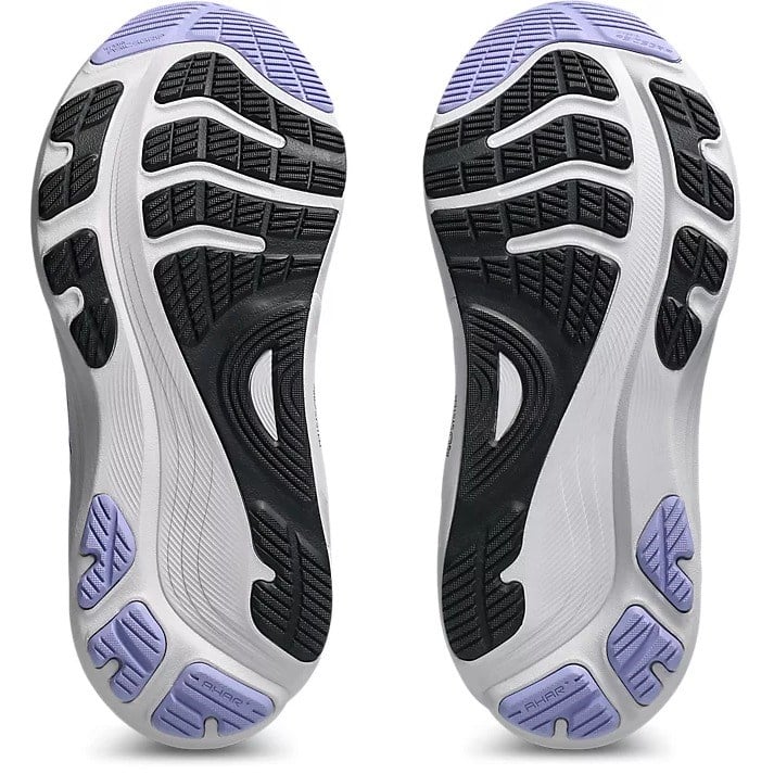 Close-up of a pair of running shoes with a focus on the sole design.