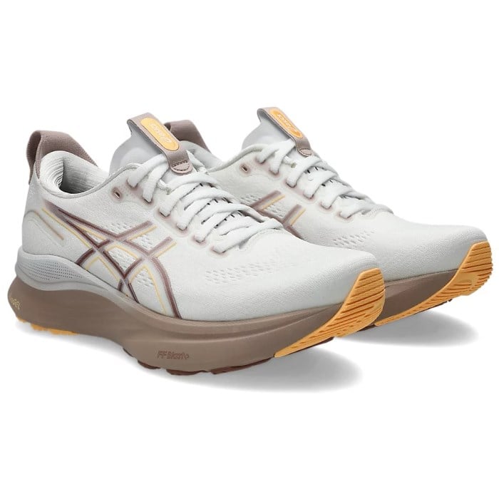 White running shoes with brown and yellow accents on a white background