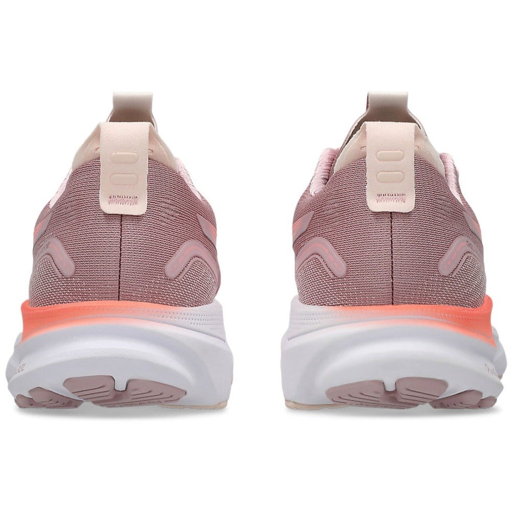 Pink running shoes with white soles on a white background