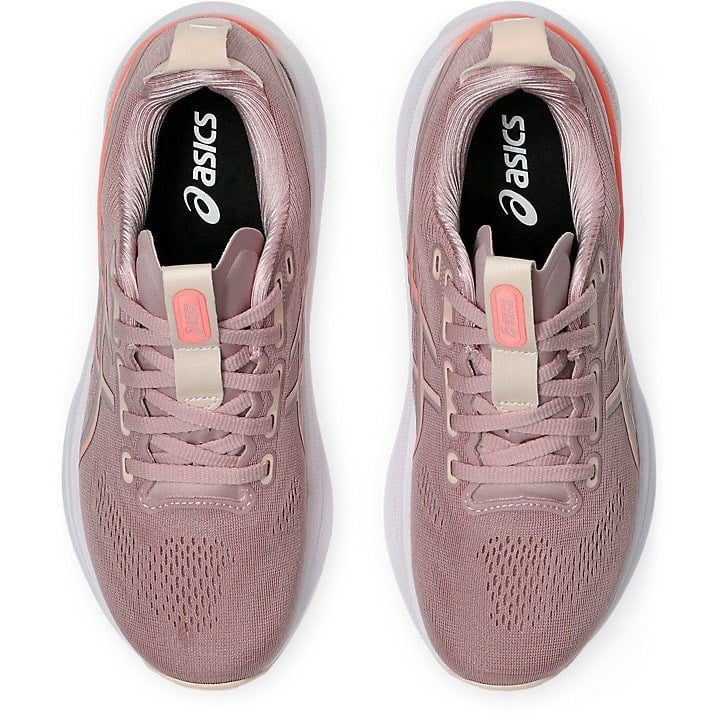 Pair of pink running shoes with Asics logo on a white background