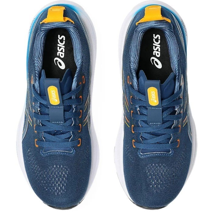 Blue running shoes with yellow accents and Asics logo on a white background