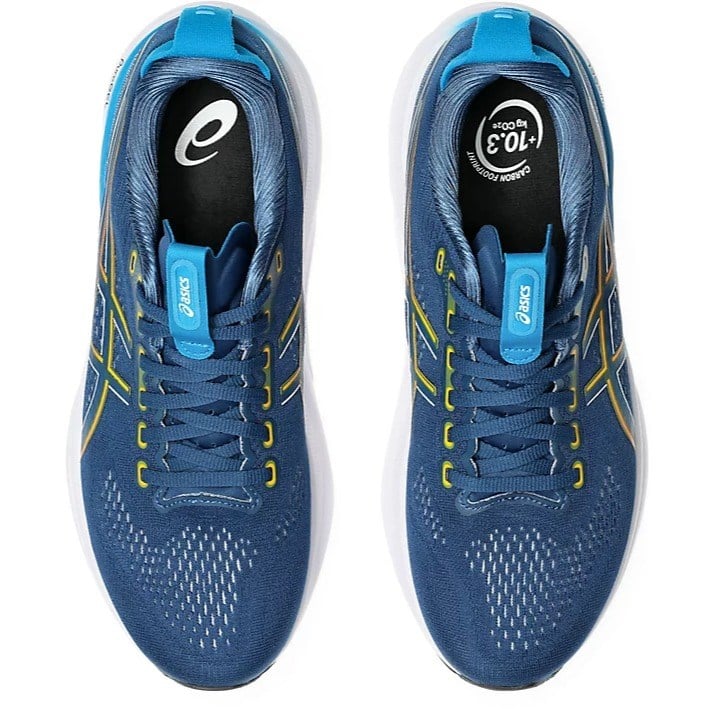 Blue running shoes with yellow accents on a white background
