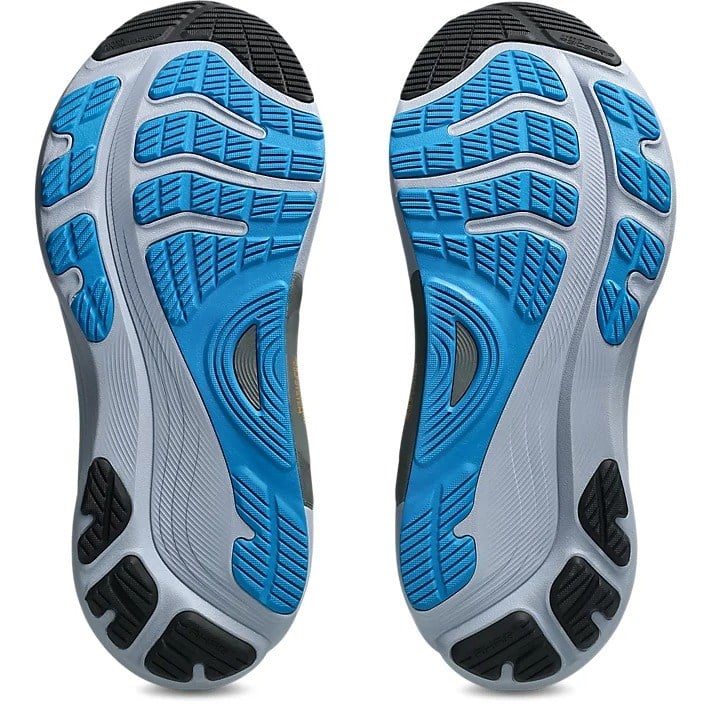 Close-up of a pair of athletic shoes with blue and gray sole on a white background