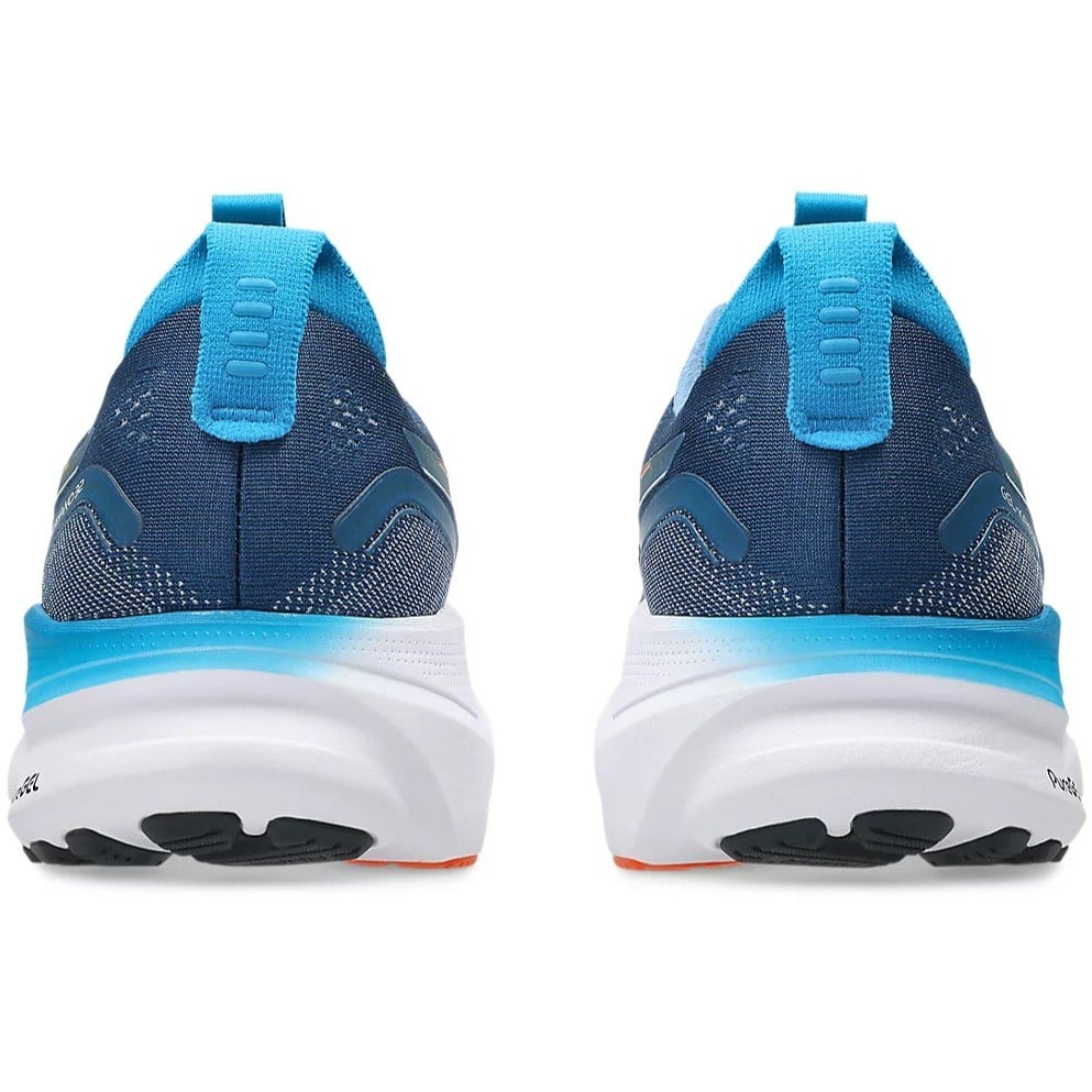 Blue running shoes with white soles on a white background