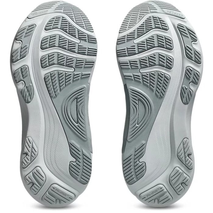 Close-up of the sole of a gray athletic shoe with tread pattern on a white background