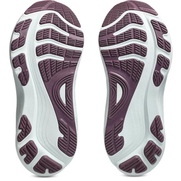 Close-up of the sole of a pair of shoes with purple and white design on a white background