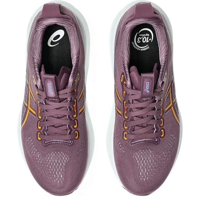 Pair of purple running shoes with gold accents on a white background