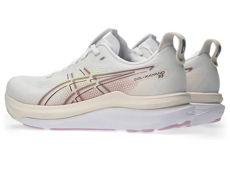 White running shoe with pink accents on a white background