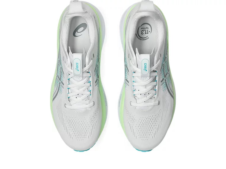 White running shoes with green accents on a white background
