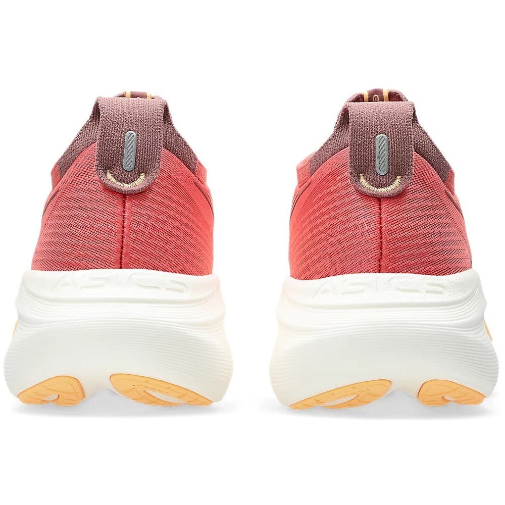 Pair of red sneakers with white soles on a white background
