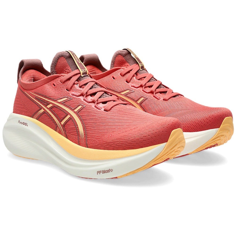 Red running shoes with yellow accents on a white background