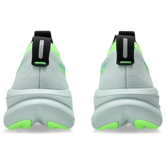 Light gray and green sneakers with black straps on a white background