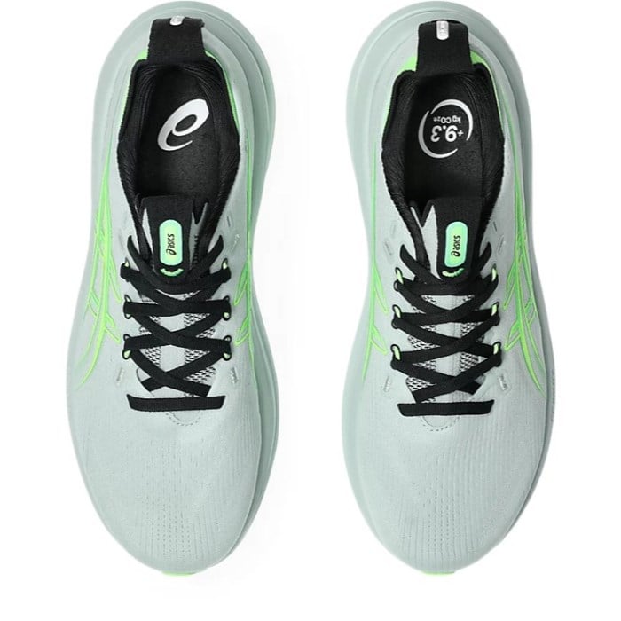 Light blue running shoes with black and green accents on a white background