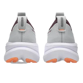 Gray athletic shoes with orange accents on a white background