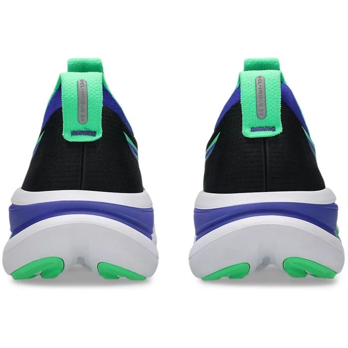 Black and blue athletic shoes with green accents on a white background