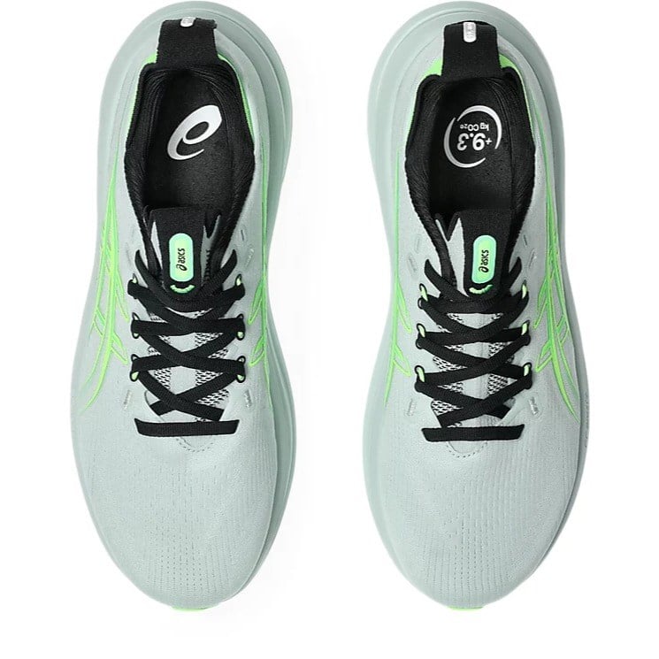 Light blue running shoes with black and green accents on a white background