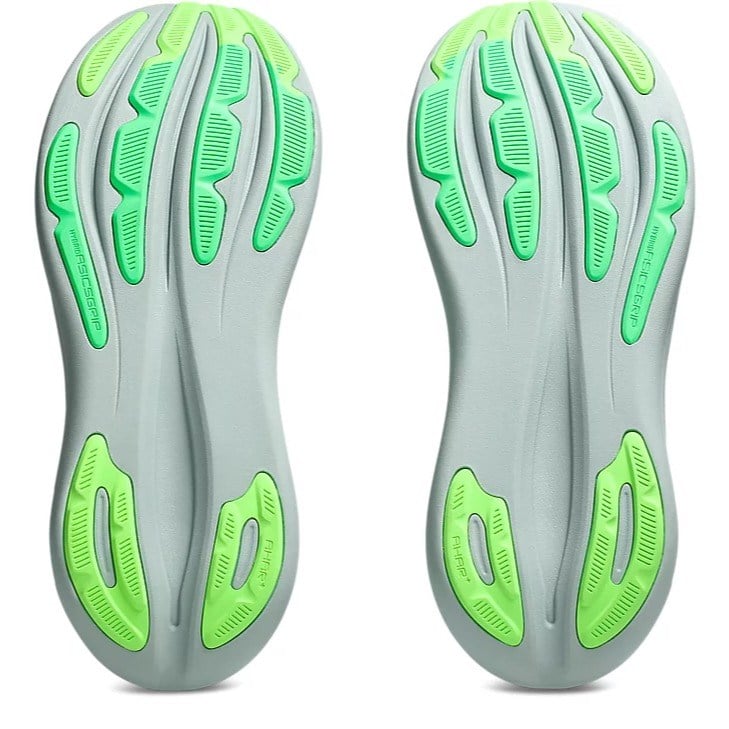 Gray and green shoe sole with unique tread pattern on a white background