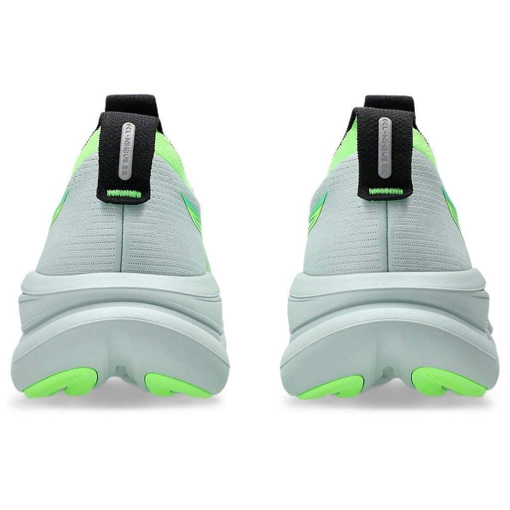 Light gray and green sneakers with black straps on a white background