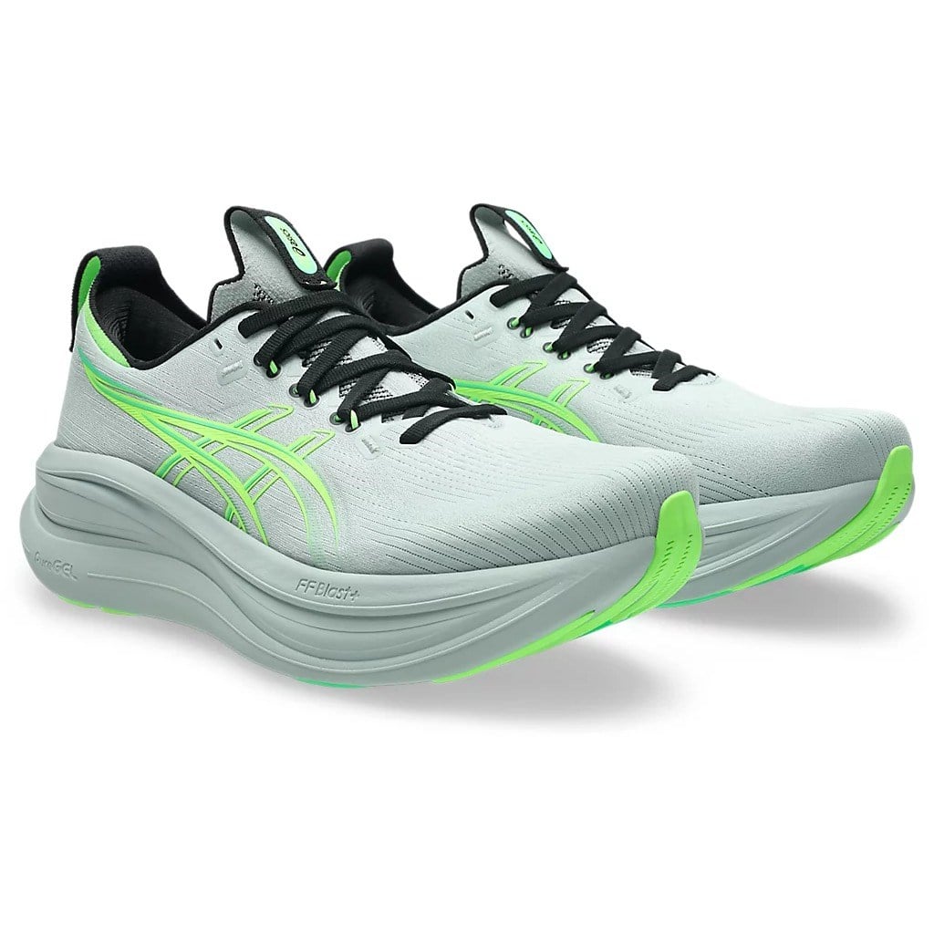 Light gray running shoes with green accents on a white background