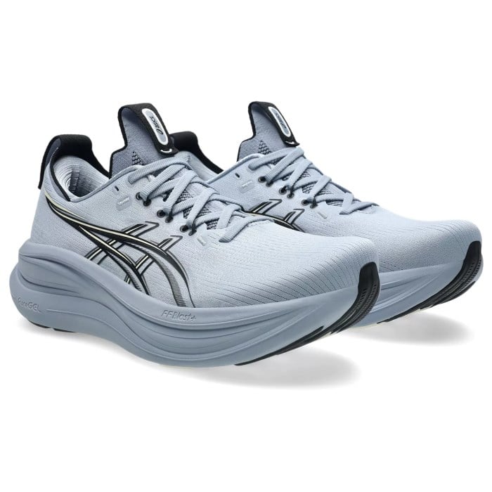 Pair of light blue running shoes with black accents on a white background