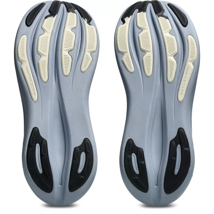 Pair of gray and black shoe soles with unique tread pattern on a white background