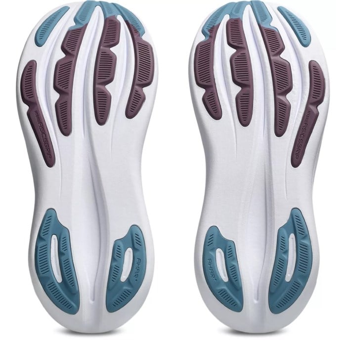 Close-up of white athletic shoes with blue and purple sole design on a white background