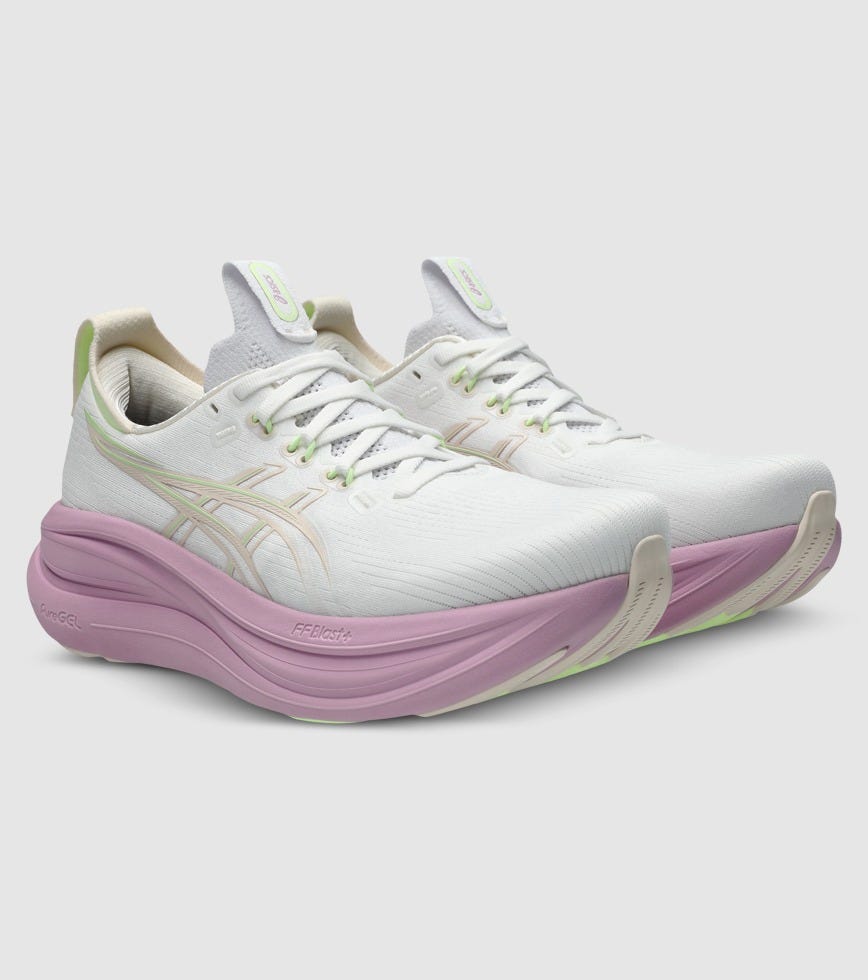 White and pink running shoes on a light gray background