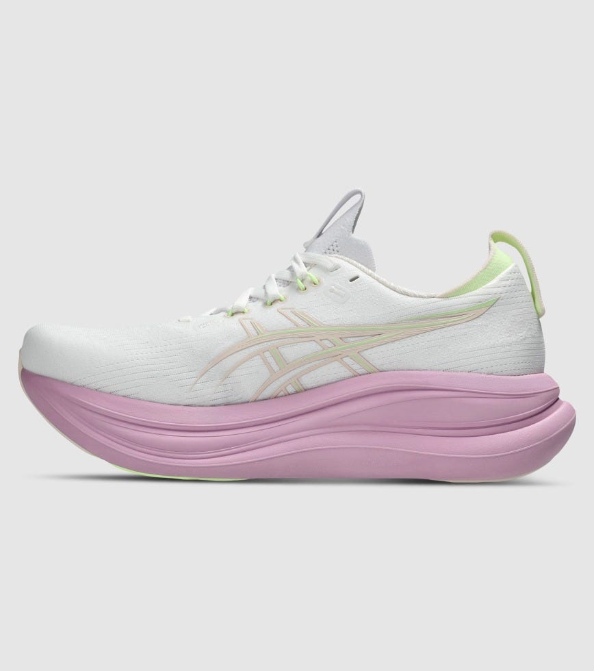 White running shoe with pink sole on a light gray background