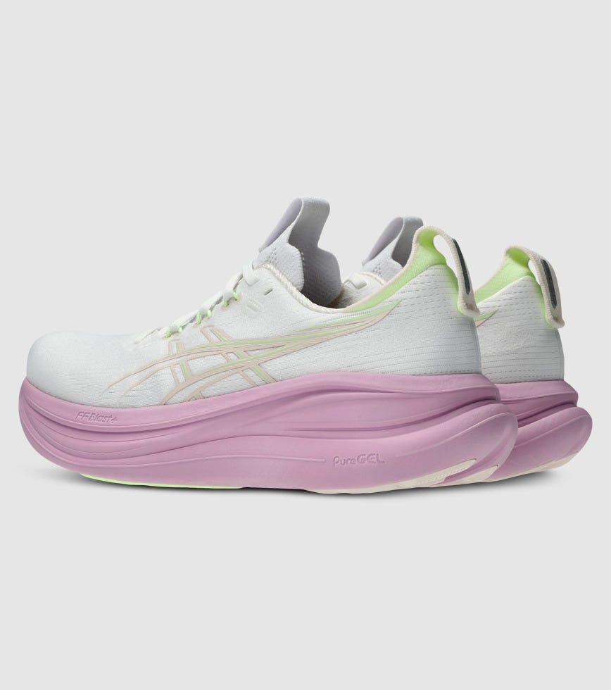 White and pink sneaker with green accents on a light gray background