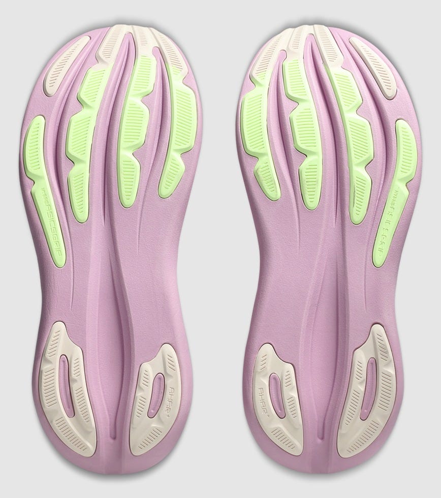 Pink and green athletic shoe sole on a light gray background