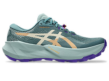 A single ASICS running shoe in a muted teal-blue colorway, featuring a light beige logo overlay, orange knit accents, and a purple outsole, shown against a plain white background.