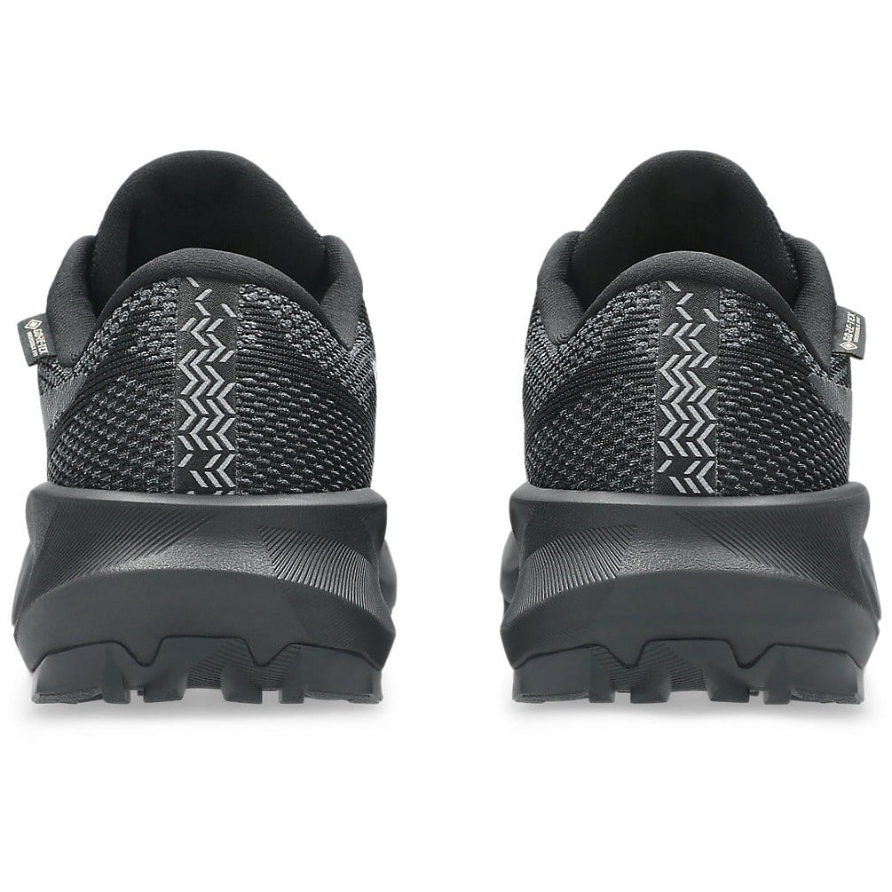 Black athletic shoes with textured sole design on a white background
