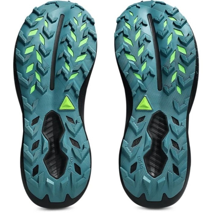 Close-up of teal and black athletic shoe soles with green accents on a white background