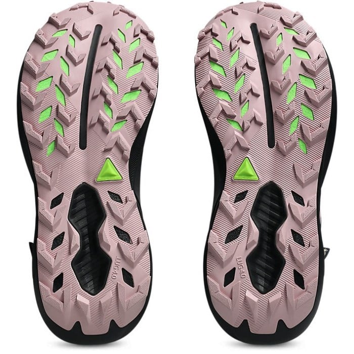 Pink athletic shoes with green accents on a white background
