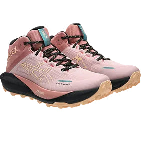 Pink hiking boots with black soles on a white background