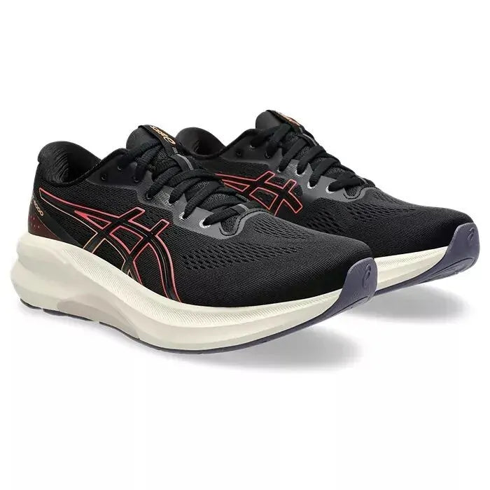 Black running shoes with red accents on a white background