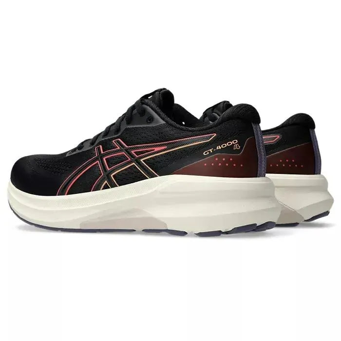 Navy running shoe with green sole on a white background
