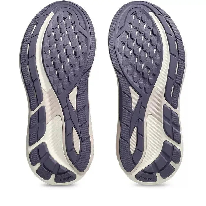 Pair of purple running shoes with white soles on a white background