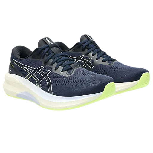 Navy running shoes with green accents on a white background