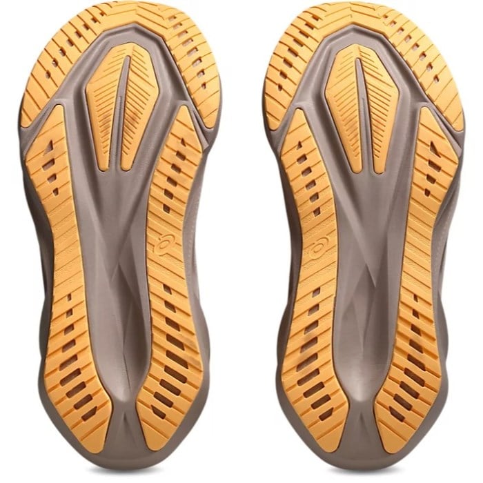 Pair of brown and orange athletic shoes with textured soles on a white background