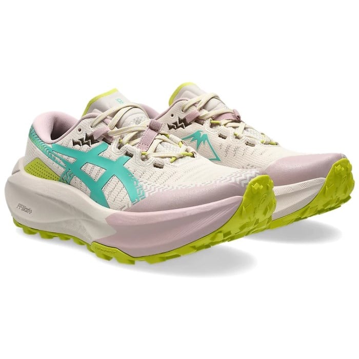 Pair of running shoes with green, pink, and white design on a white background