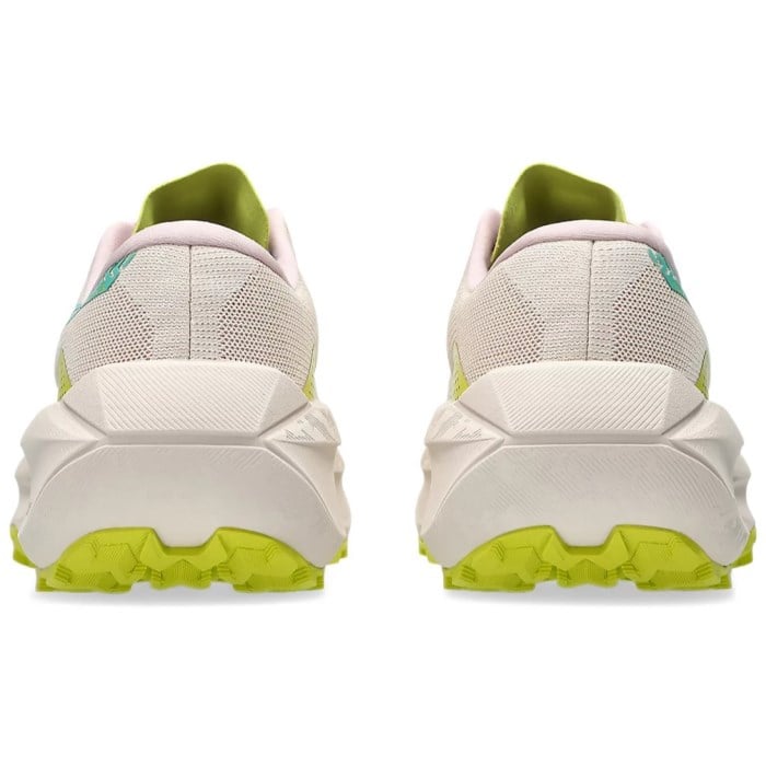 White running shoes with green accents on a white background