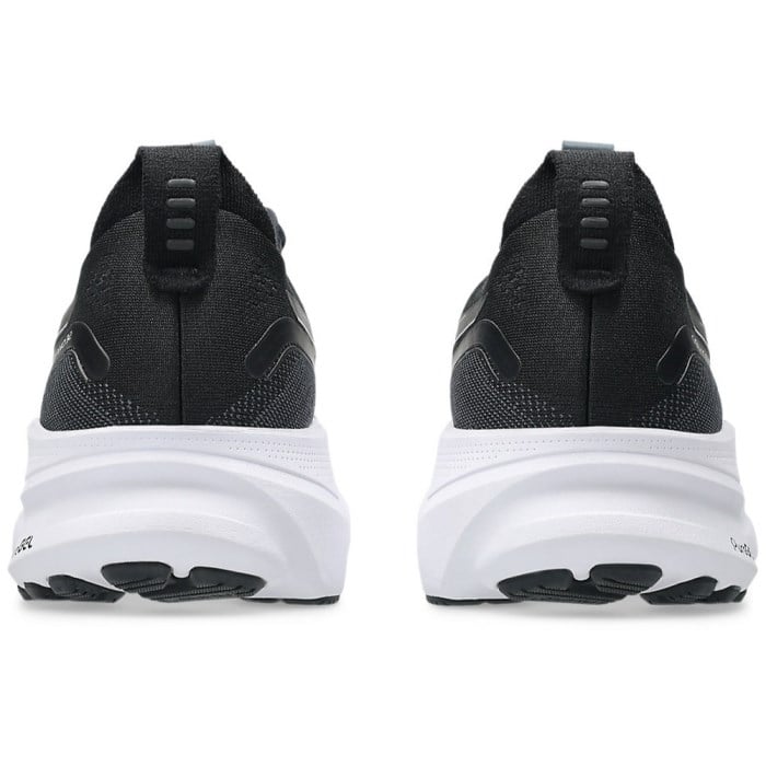 Black running shoes with white soles on a white background