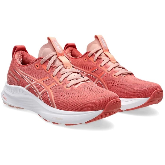 Pair of coral running shoes on a white background