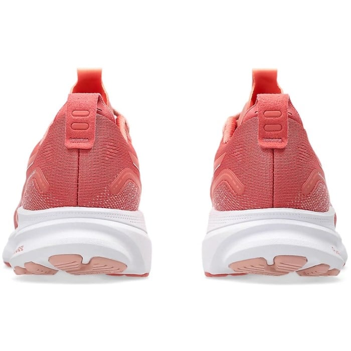 Pair of pink running shoes with white soles on a white background