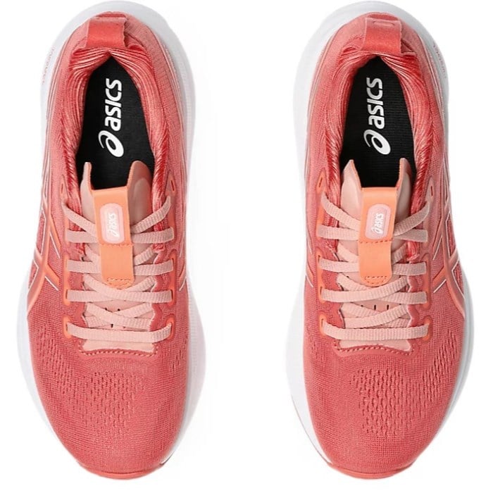 Pair of coral running shoes with white laces on a white background, featuring the Asics logo.